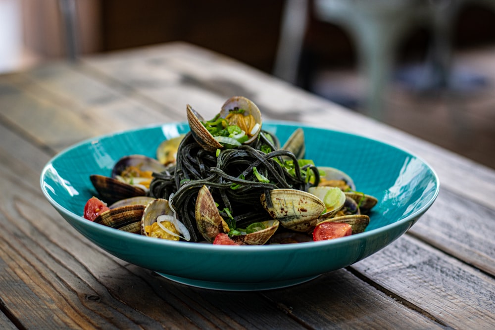 sliced vegetables on blue ceramic bowl