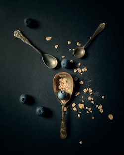 silver spoon and fork on blue surface
