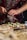 A cozy kitchen scene with a person preparing a healthy pizza on a rustic countertop.