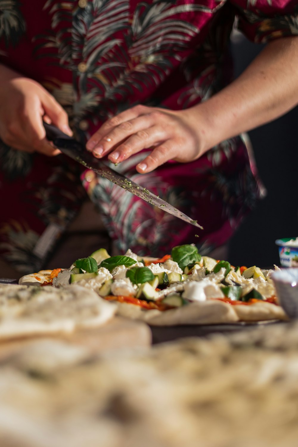 person holding knife slicing vegetable