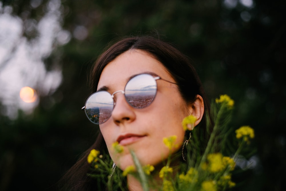 woman in black sunglasses with yellow flower on her ear