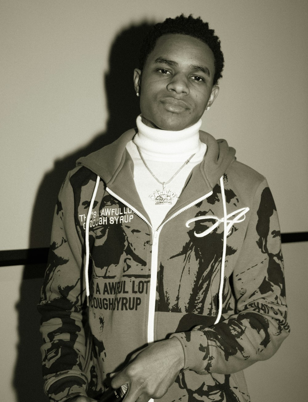 man in camouflage jacket standing near wall