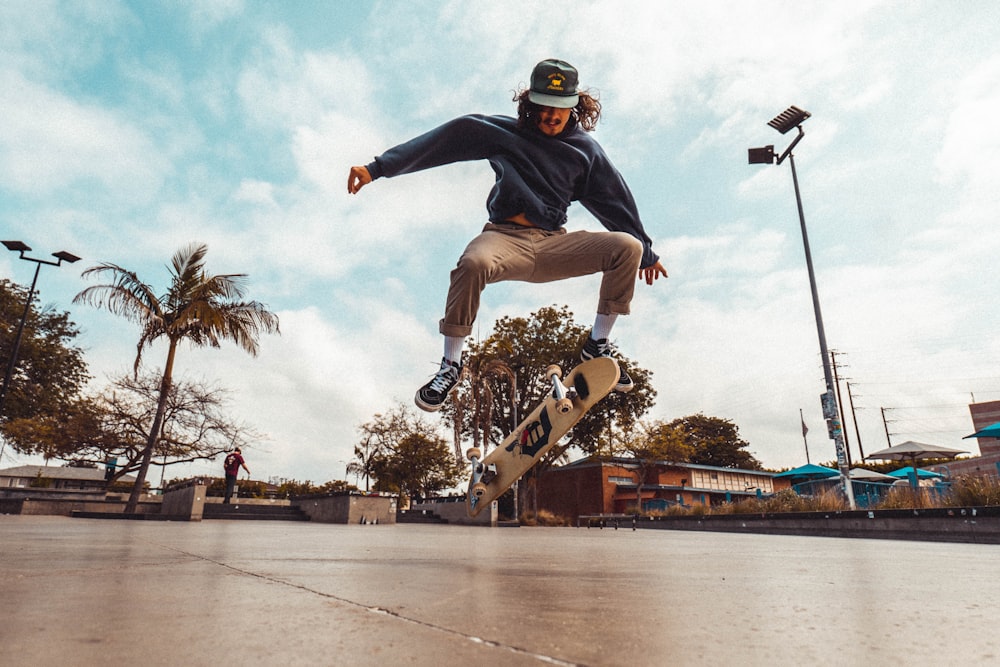 man in black shirt and brown pants riding skateboard during daytime