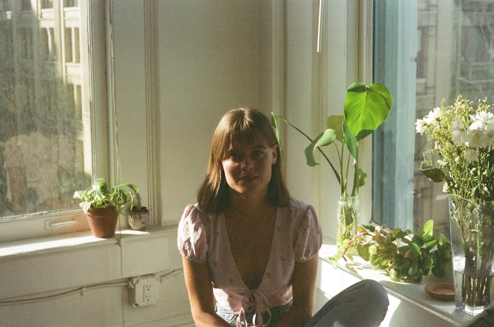 woman in brown button up shirt sitting on white plastic chair