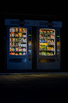 Vibrant Go vending machine inside a busy university hallway, surrounded by students.