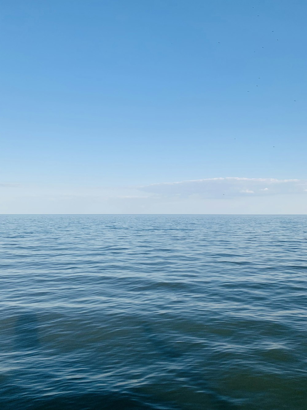 blue sea under blue sky during daytime