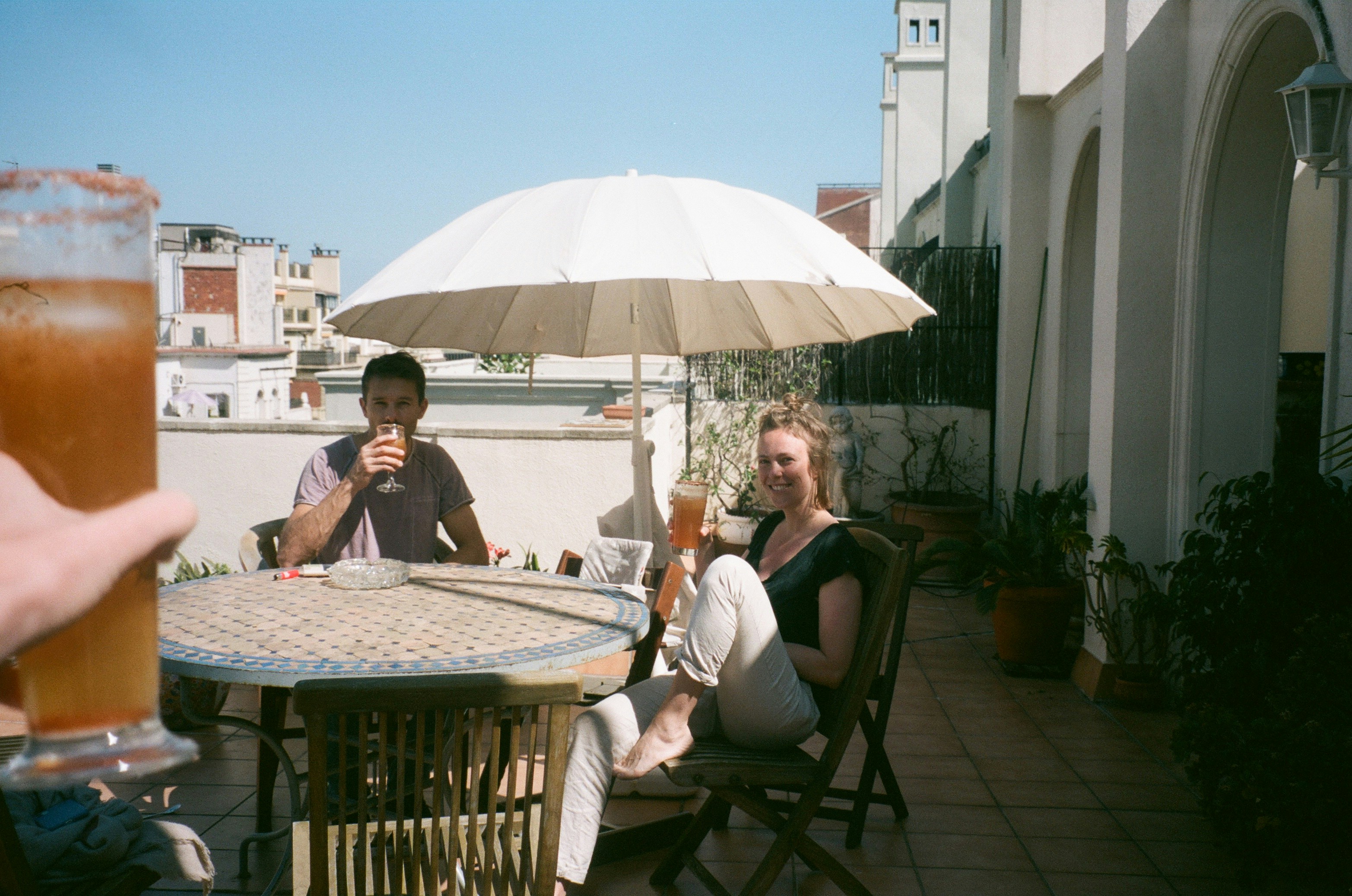 2 women sitting on chair near table