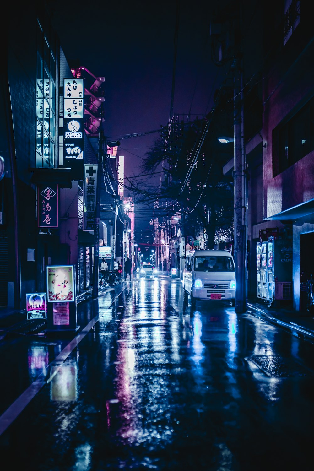 cars parked in front of store during night time