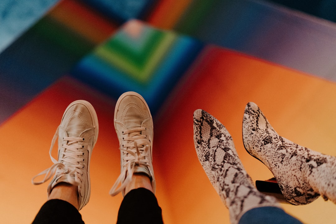 person wearing white lace up sneakers,