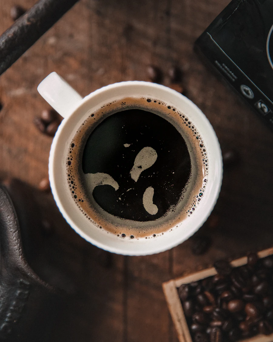 Black coffee in a white cup on a dark table