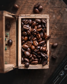 a wooden box filled with lots of coffee beans