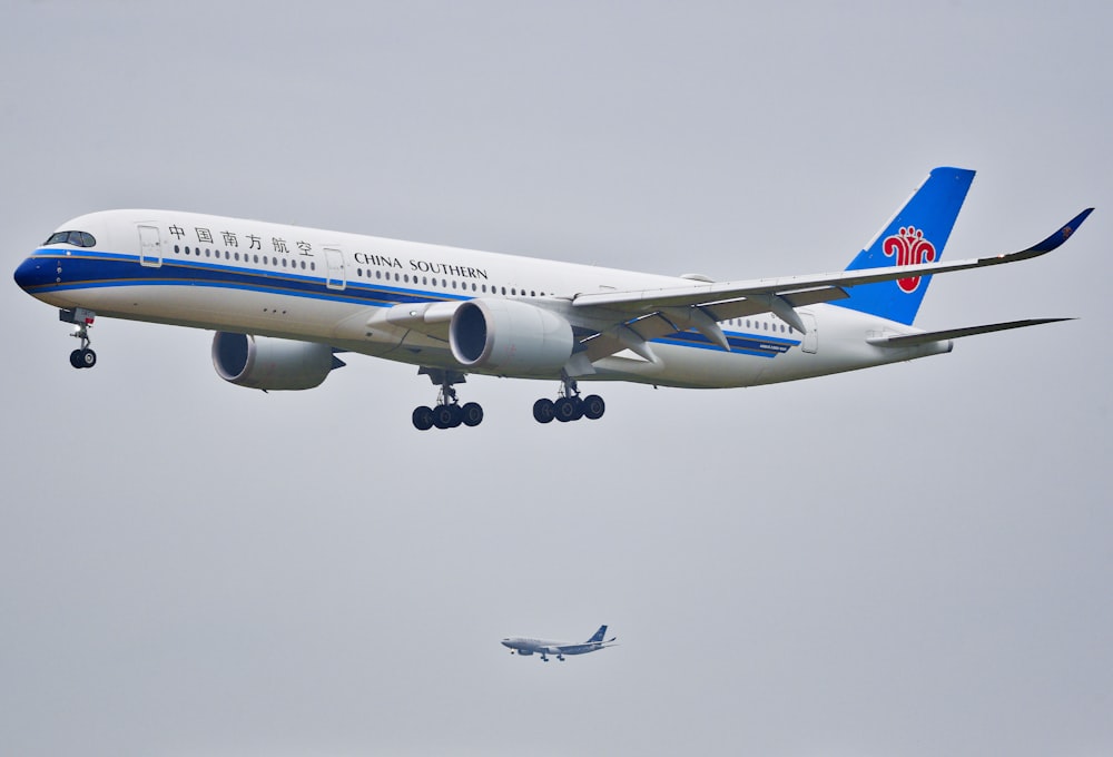 white and blue air plane flying during daytime