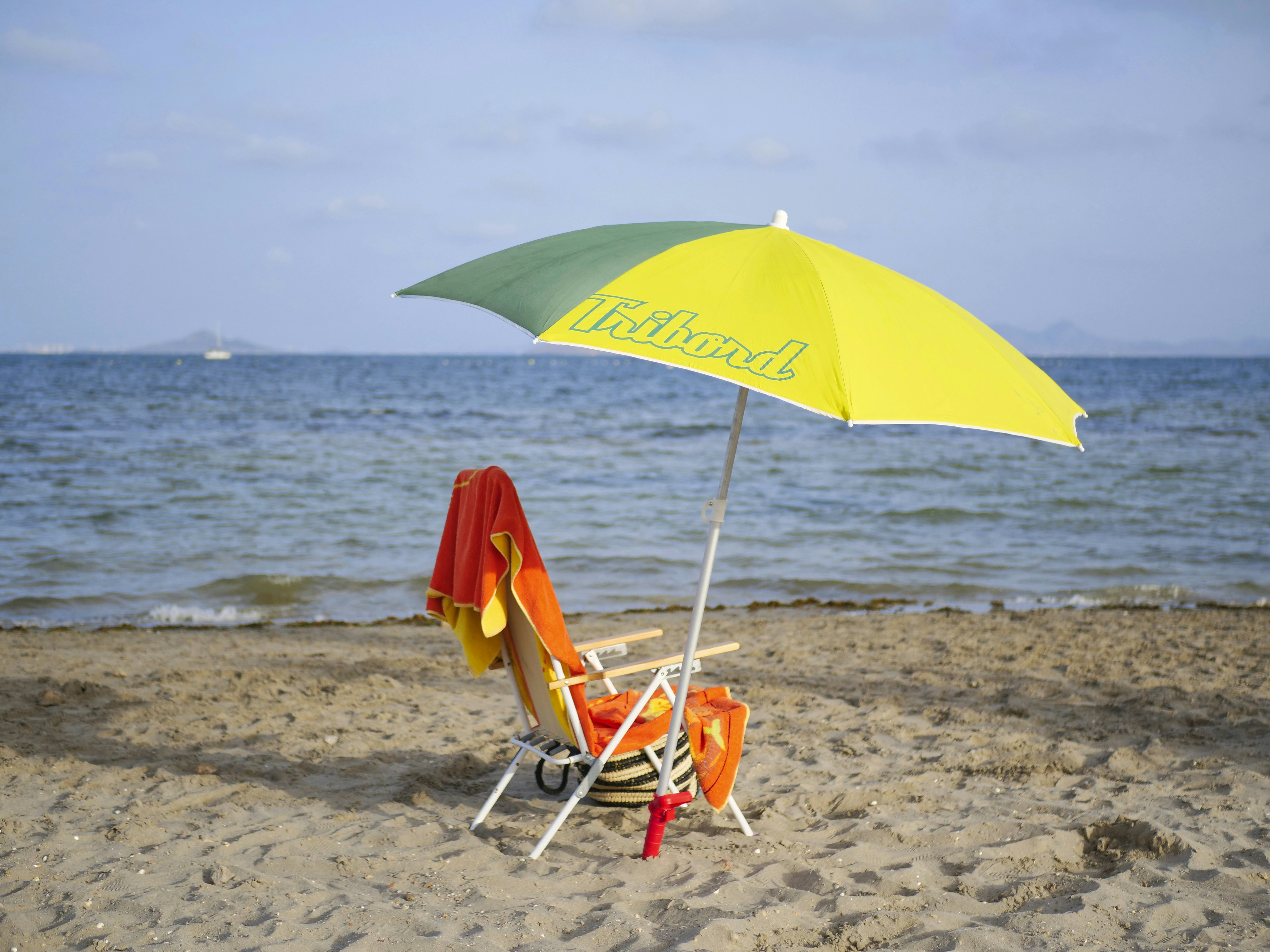 yellow umbrella on beach during daytime