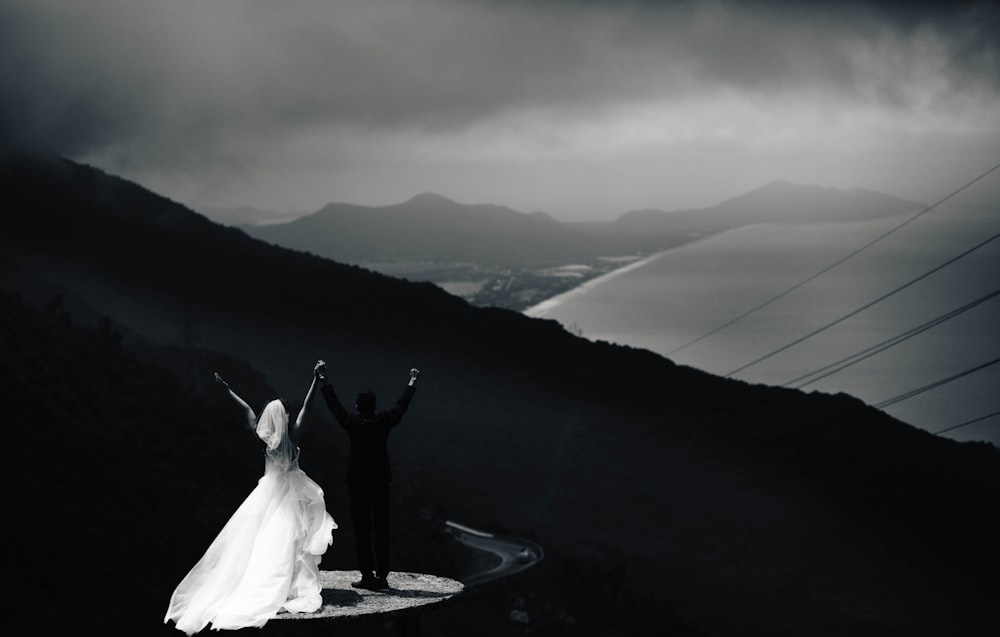 woman in white dress standing on top of mountain