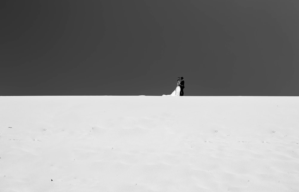 person walking on snow covered field