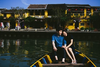 woman in blue shirt sitting on blue boat during daytime