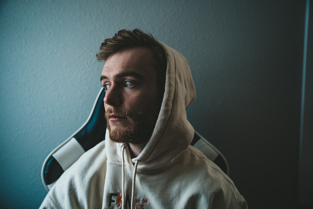 man in gray hoodie taking selfie