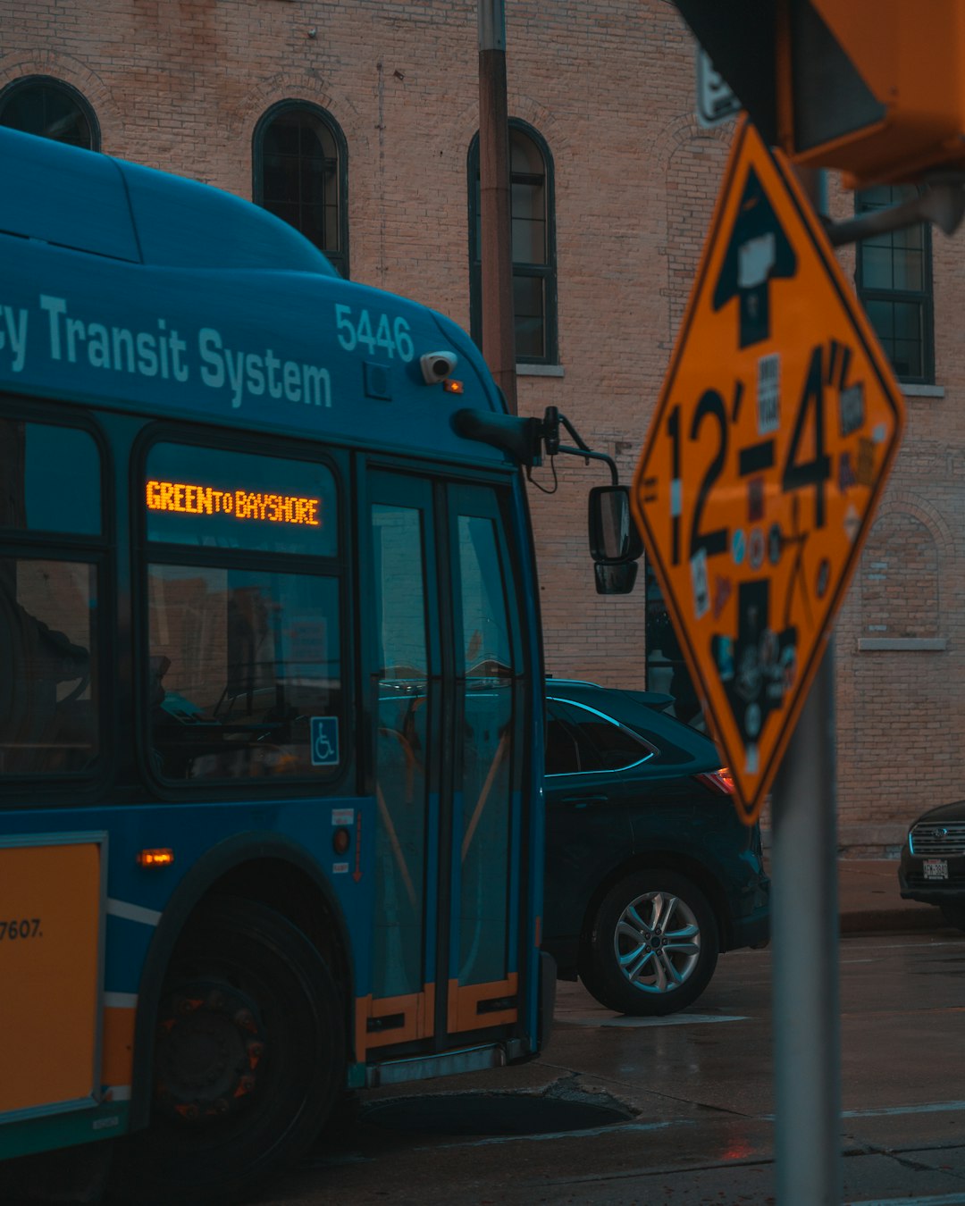 blue and orange bus on road during daytime