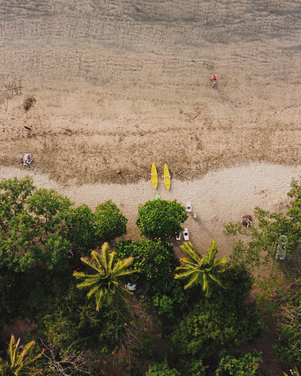 aerial view of people walking on sand during daytime
