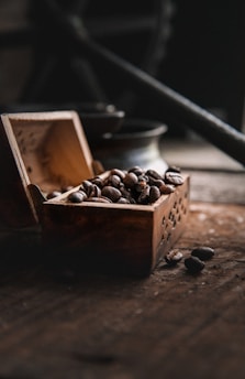 Elegant coffee beans in a wooden box with a rustic backdrop, hinting at rarity.