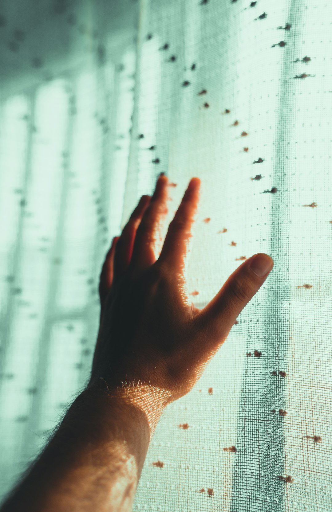 persons left hand on white textile