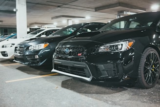 black bmw car parked on parking lot during daytime