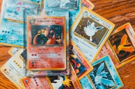 An array of pokemon trading cards fanned out on a table