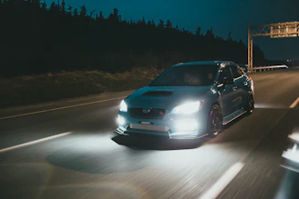 gray car on road during night time