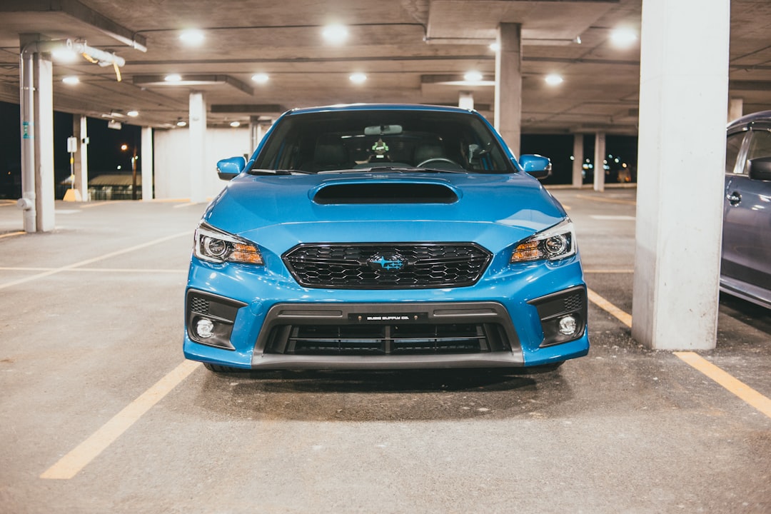 blue chevrolet car parked on parking lot during night time