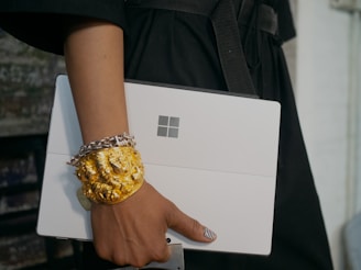 person in black shirt holding Surface computer
