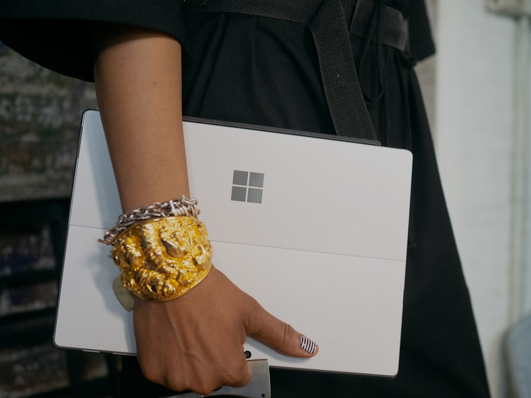 person in black shirt holding Surface computer