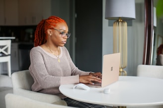 woman in gray knit sweater using Surface computer