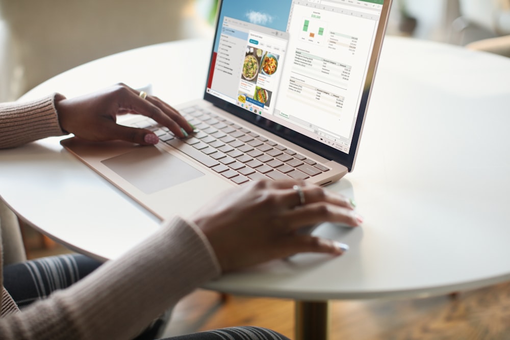 person in gray long sleeve shirt using Surface computer