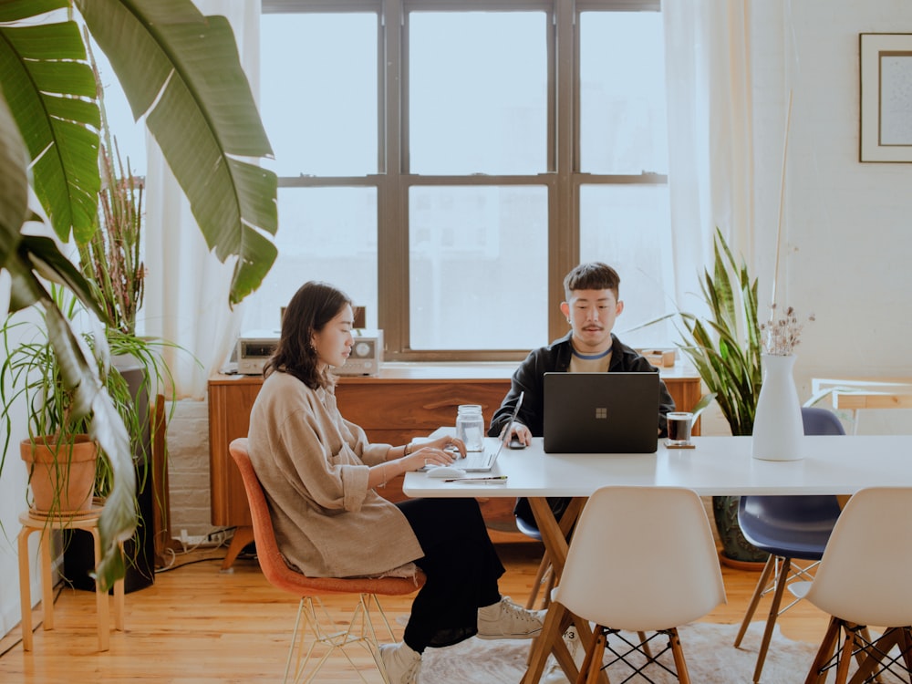 2 people sitting at table working