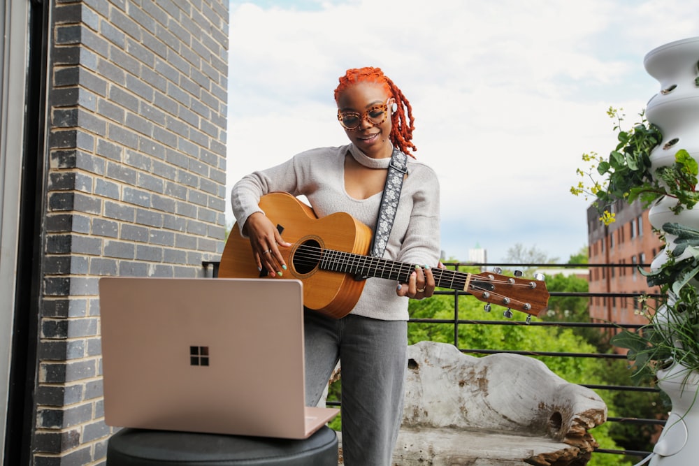 woman playing acoustic guitar