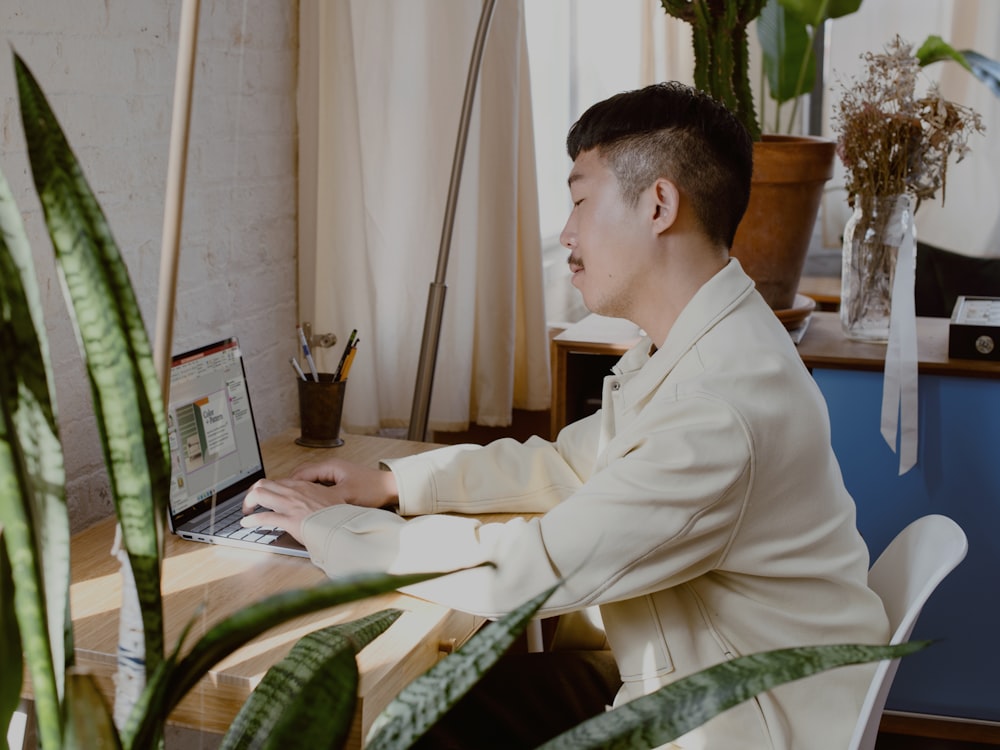 man in white dress shirt sitting on chair