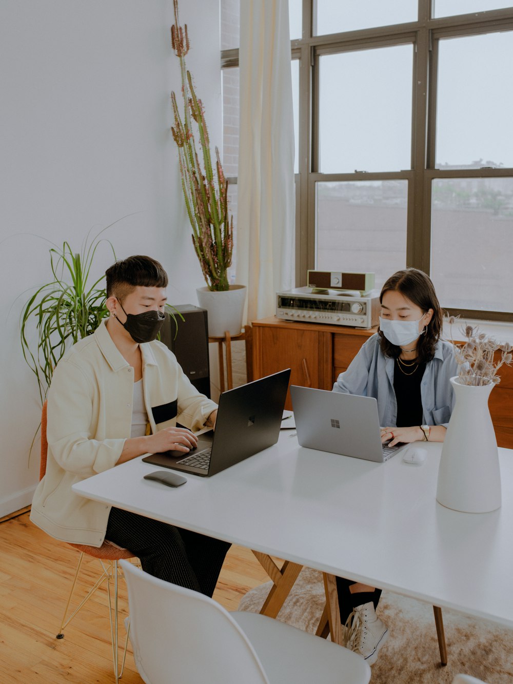 2 people sitting at table working