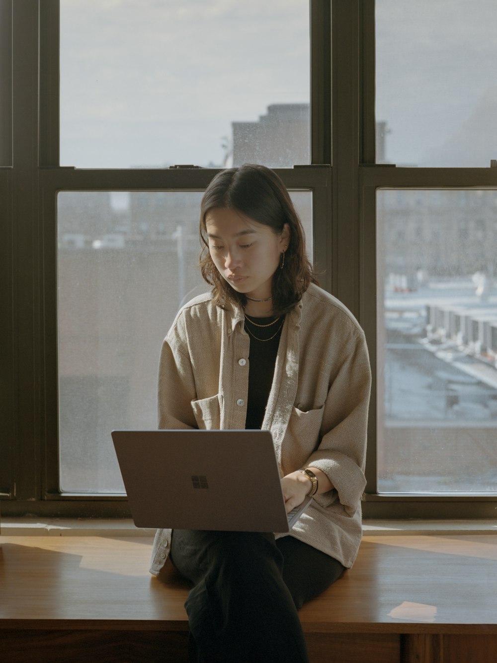 woman in white shirt using Surface computer