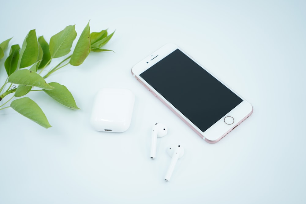 silver iphone 6 beside white apple earpods