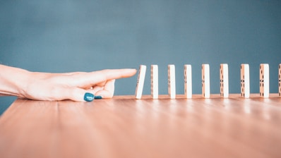 person holding white and blue plastic blocks