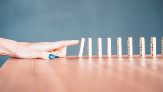person holding white and blue plastic blocks