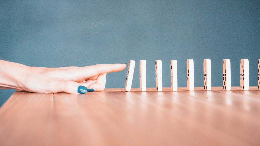 person holding white and blue plastic blocks