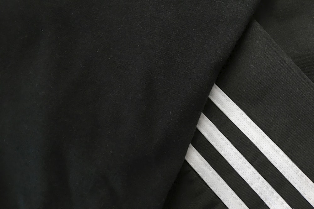 black and white textile beside black textile