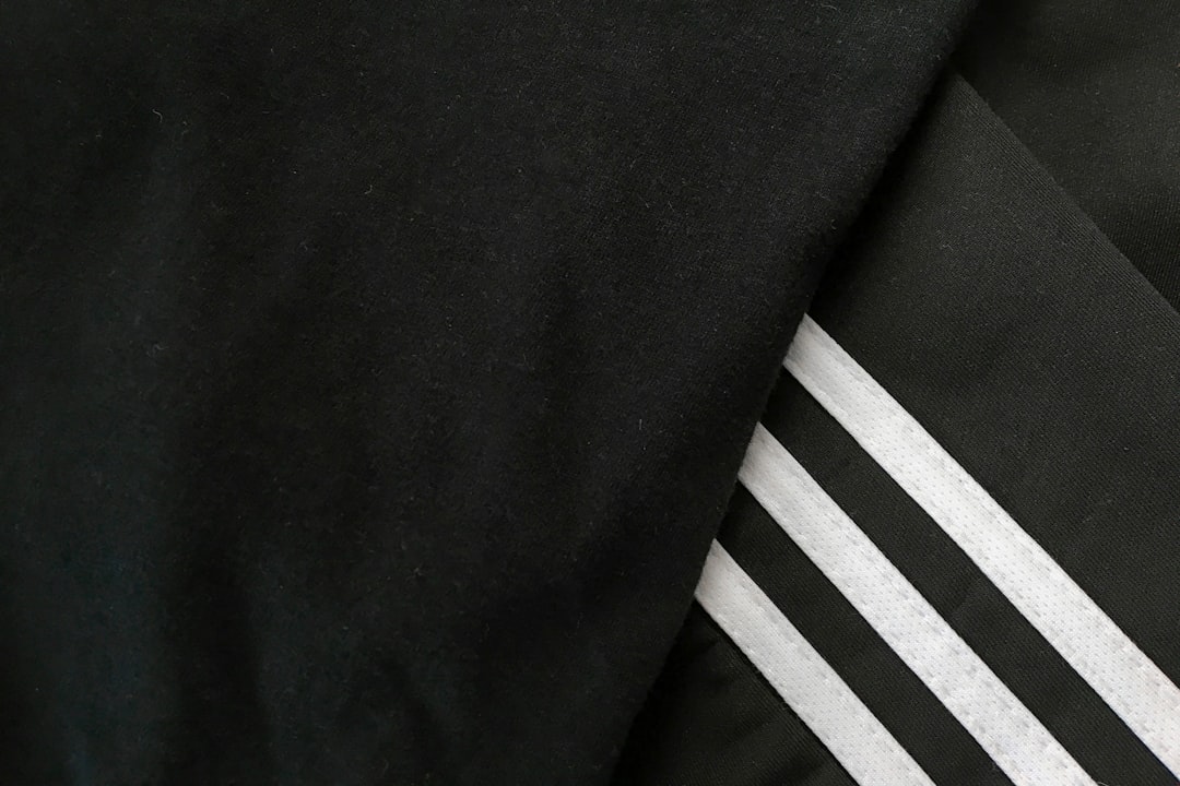 black and white textile beside black textile