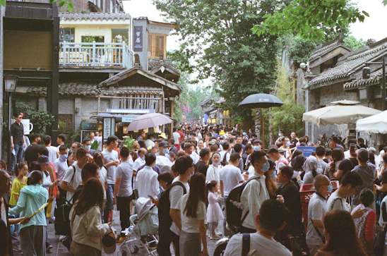 A vibrant street scene showing diverse people using their phones to connect with local services nearby.