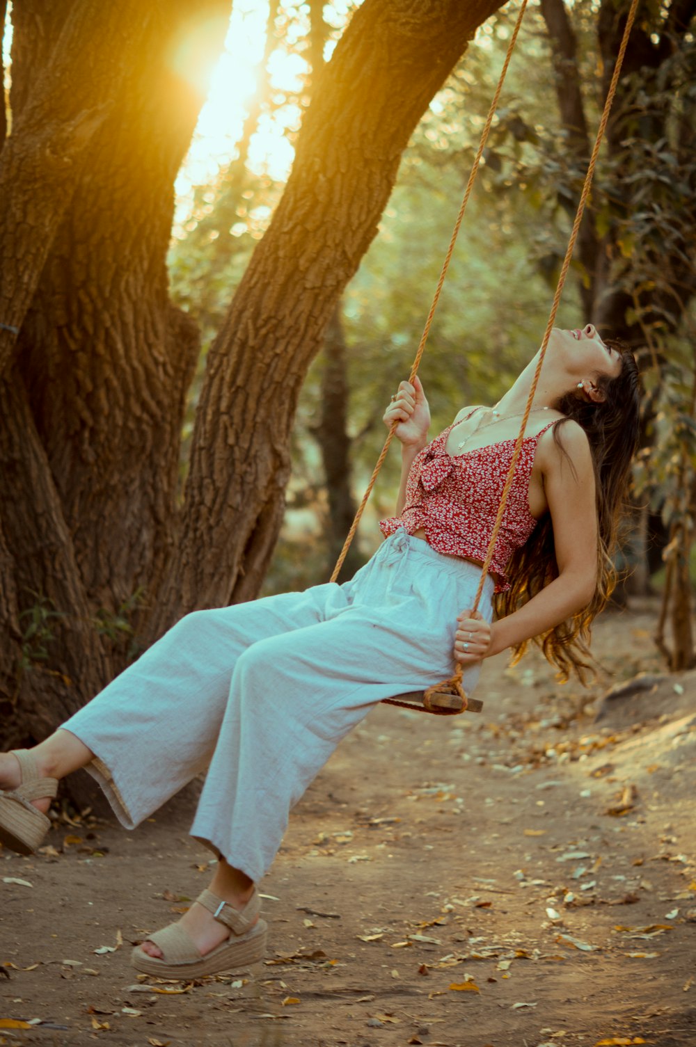 woman in white dress lying on hammock