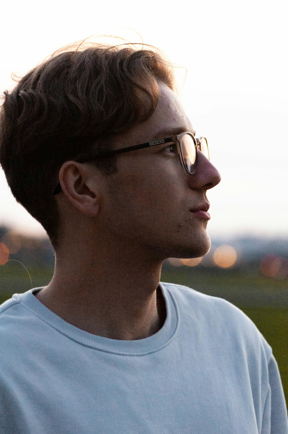 man in white crew neck shirt wearing black framed eyeglasses