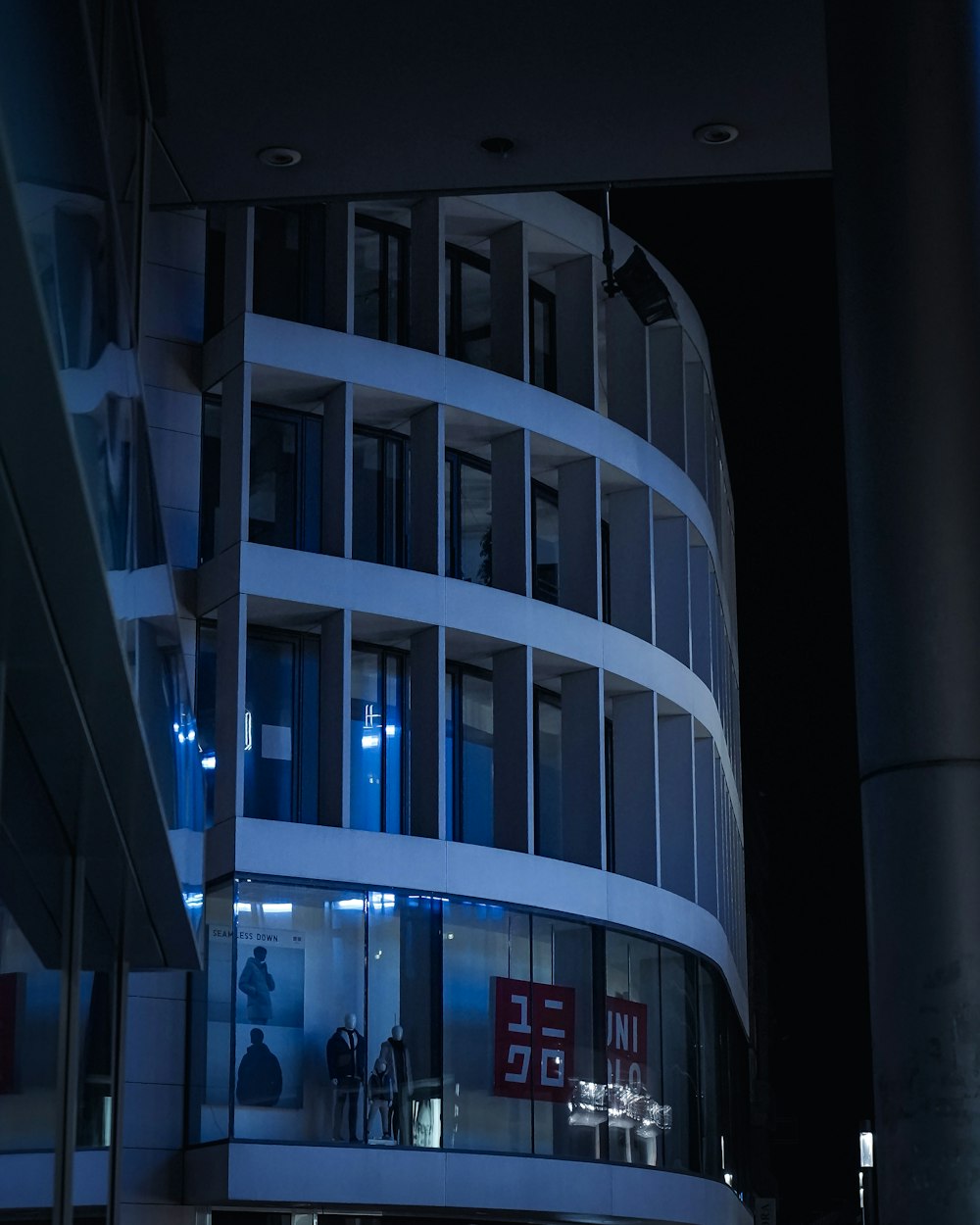 people walking on sidewalk near building during night time