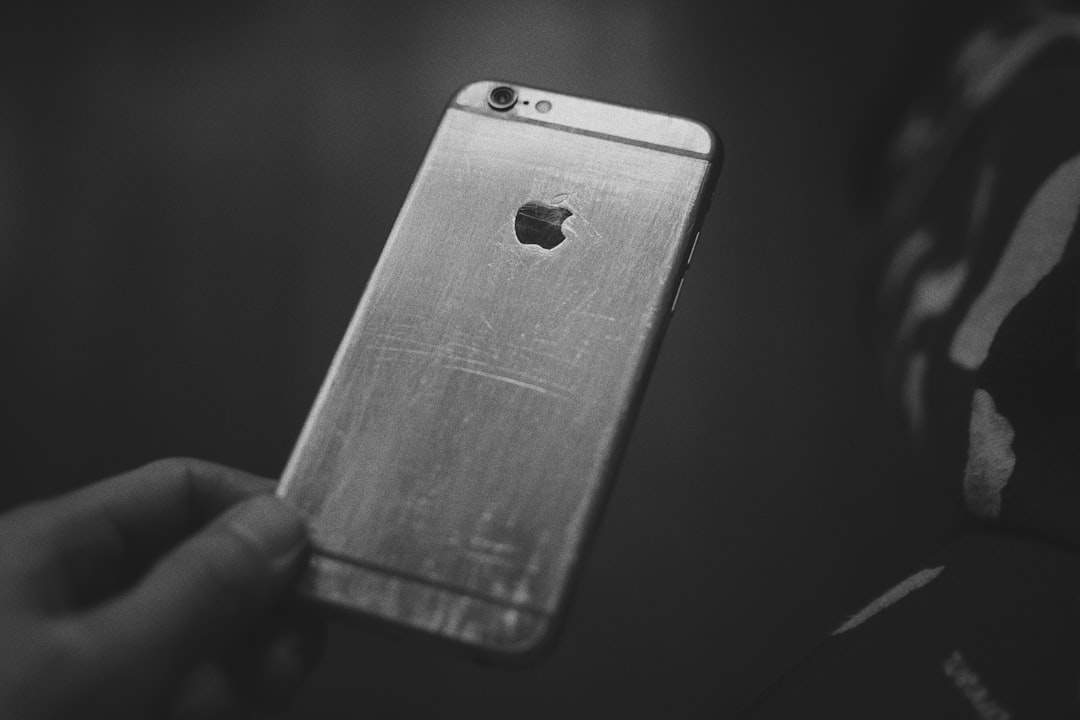 grayscale photo of person holding iphone