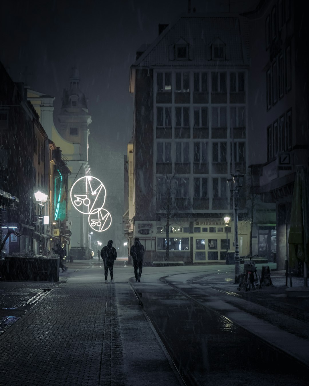 man in black jacket walking on sidewalk during night time